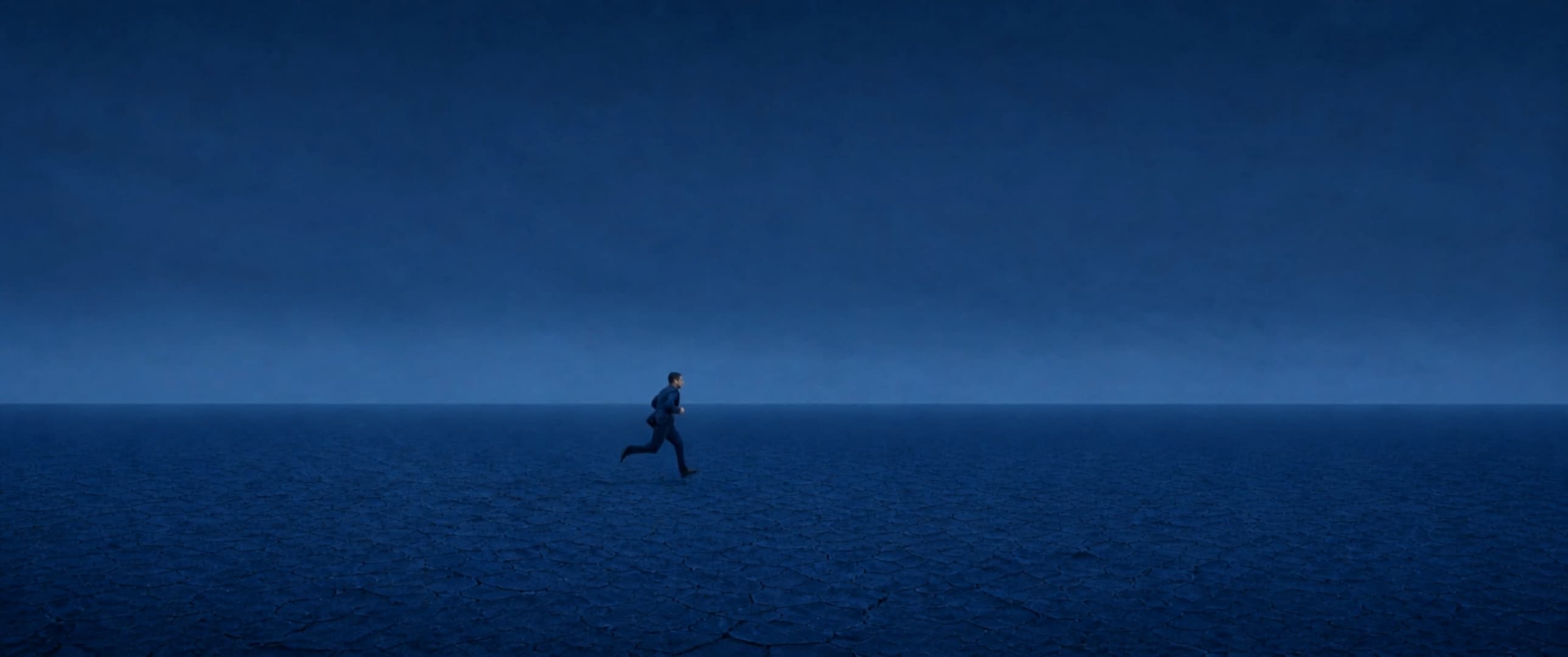 Still from The Blue Void — a figure in blue running across an empty blue plain